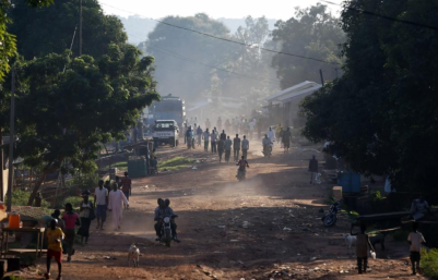 (Photo: Reuters/GORAN TOMASEVIC) People walk along a main street in the Central African Republic capital of Bangui where at least 30 people were killed in an attack by Muslim extremists on a Christian church at a refugee camp on May 28, 2014.