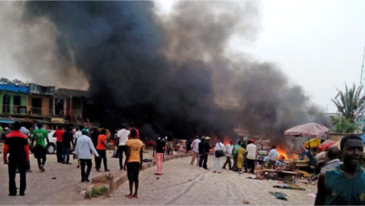  Smoke rises after a bomb blast at a bus terminal in Jos, Nigeria. Two explosions ripped through a bustling bus terminal and market frequented by thousands of people in Nigeria's central city of Jos on Tuesday afternoon. (AP Photo/Stefanos Foundation),