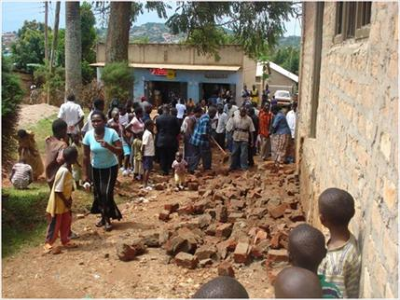 The members of World Possessor's Church International, in Namasuba, Uganda, examine the rubble left after an extremist Islamist attack during their worship service. November 2009 (PHOTO: World Watch Monitor)