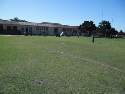 The sports field and school building that were covered in fire in Siphoyethu's vision.