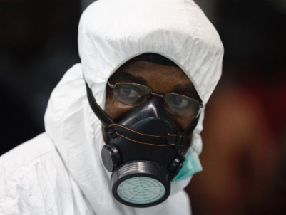 A Nigerian health official wears protective gear August 6 at the Murtala Muhammed International Airport in Lagos, Nigeria. (PHOTO: CNN)