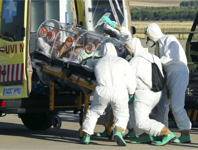 Health workers load Ebola patient, Spanish priest Miguel Pajares, into an ambulance on the tarmac of Torrejon airbase in Madrid, after he was repatriated from Liberia for treatment in Spain, August 7, 2014. (PHOTO: REUTERS/MINISTRY OF DEFENCE/HANDOUT VIA REUTERS)