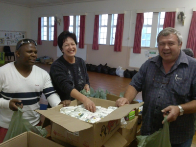 Joel Stuurman, Lizette Rheeder and Andrew Johnson share a joke whilst packing the toiletry bags for the guests.