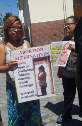 The vigil participants use posters to create awareness about the consequences of abortion and various alernatives to abortion that are available. (PHOTO: Mieta Sishuba).