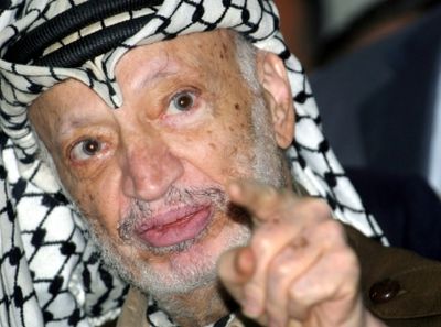 Then-President Yasser Arafat talks to the media two months before his death in 2004