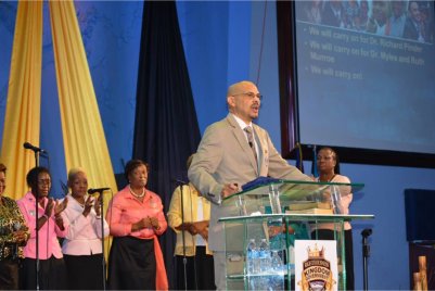 (PHOTO: FACEBOOK/KEVIN "MINISTER K" HARRIS) Dave Burrows (podium), the new senior pastor of Myles Munroe's Bahamas Faith Ministries.