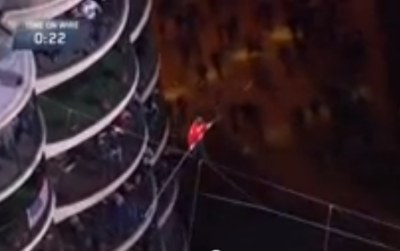 Blindfolded Nick Wallenda steps out on a tightrope between two Chicago skyscrapers.