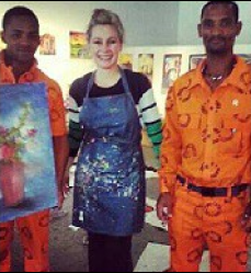 Lisa Crumpton poses with two offenders on the last day of the art workshop.