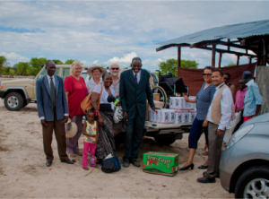 A second wheelchair as well as food and other gifts were handed over to Pastor Vincent at a church in Akweira. Mission trip members are Barbara Bresler (second from left) and Louise and Peter Dawson (to the right of Barbara).