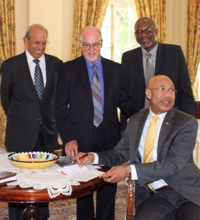 The Governor General of Jamaica,  His Excellency Sir Patrick Allen, signs the UE pledge. He is witnessed by (from left) Robert Levy, Graham Power and Oral McCook.