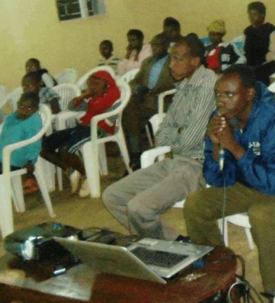 Rwanda group watching a webinar on a screen.