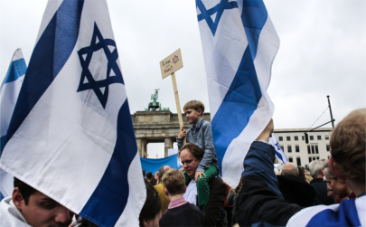 People with Israeli flags and banners attend a rally against anti-Semitism near the Brandenburg Gate in Berlin on Sunday.