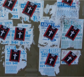 Illegal abortion posters -- partially covered by prolife stickers.