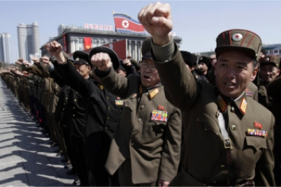 North Korean army officers punch the air as they chant slogans during a rally at Kim Il Sung Square in downtown Pyongyang, North Korea (P