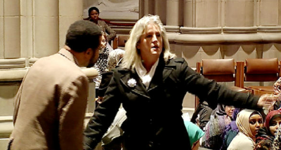 A Christian woman protester interrupts the first Muslim prayer service at the National Cathedral, Washington on Friday (PHOTO: video screenshot).