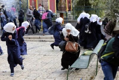 REUTERS Palestinians run for cover as Israeli police use stun grenades to disperse a crowd trying to enter the compound known to Muslims as Noble Sanctuary and to Jews as Temple Mount in Jerusalem's Old City, November 5, 2014.